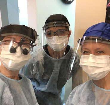 The David Paulussen, DMD team wearing their PPE of surgical masks and face shields