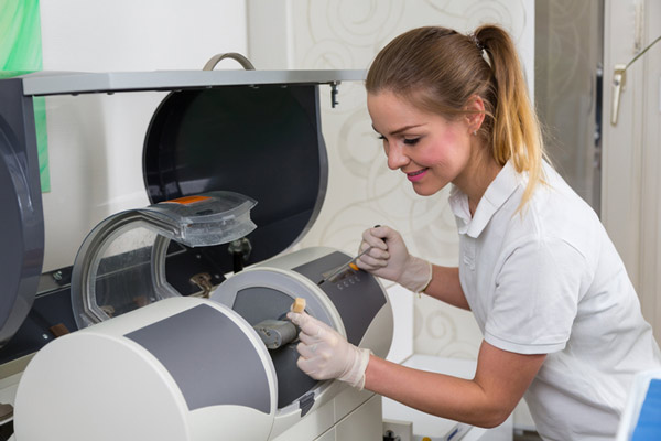 Dental assistant assisting with CEREC technology in Hackettstown, NJ