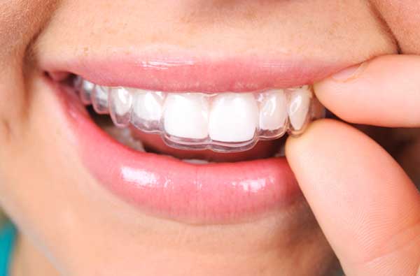 Woman using clear aligner in Hackettstown, NJ